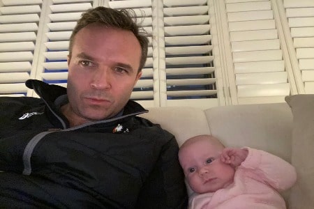 He is taking a selfie with a baby girl.